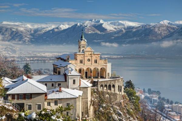 La Madonna del Sasso innevata con il Lago Maggiore sullo sfondo.
